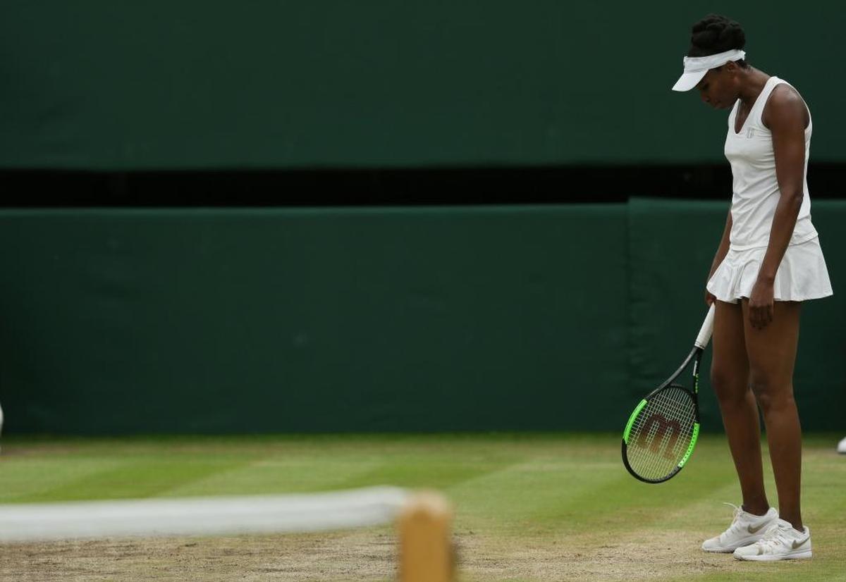 Venus Williams of the United States looks down after loosing a point against Spain's Garbine Muguruza during their Women's Singles final match on day twelve at the Wimbledon Tennis Championships in London Saturday, July 15, 2017.