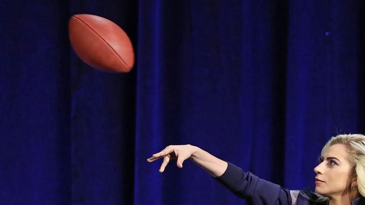 Lady Gaga throws her official game ball into the crowd during the Super Bowl LI halftime show press conference on Thursday, Feb. 2, 2017, in Houston.