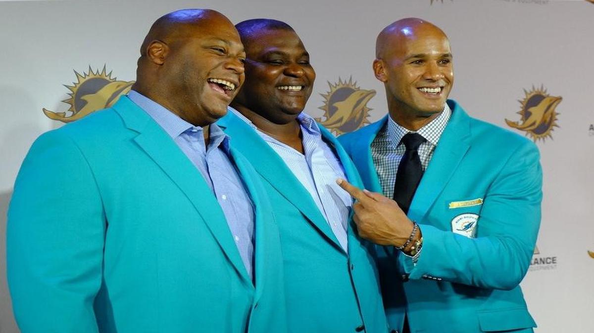 From left, Jeff Cross, Tim Bowens and Jason Taylor pose for a photo during the red carpet portion of the Dolphins’ gala event in celebration of their 50th season and 50 greatest players in franchise history on Friday night at the Diplomat Resort & Spa in Hollywood.