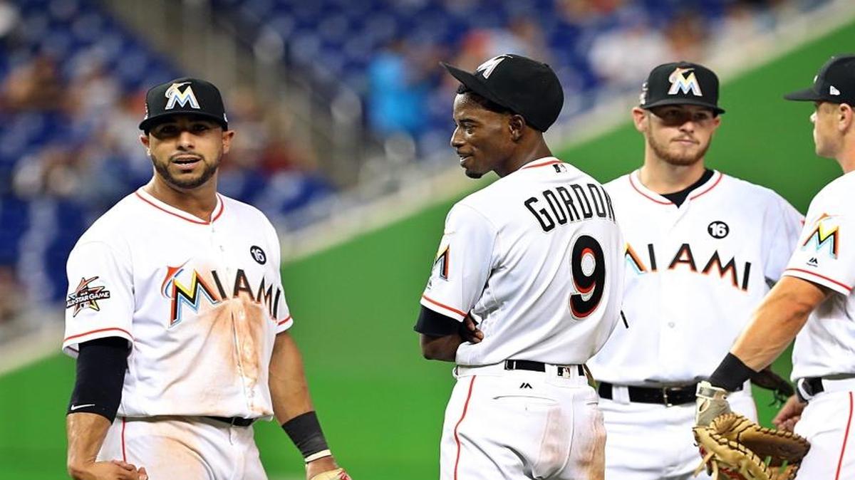 From left: Mike Aviles, Dee Gordon, J.T. Riddle and Tyler Moore react as Jarlin Garcia throws warm-up pitches in the sixth inning of the Miami Marlins’ game against the Houston Astros at Marlins Park in Miami on May 16, 2017.