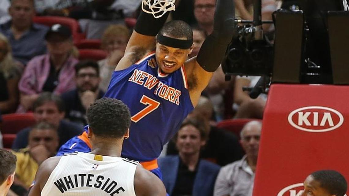 Miami Heat guard Goran Dragic, center Hassan Whiteside and guard Rodney McGruder, couldn't stop Knicks' forward Carmelo Anthony from dunking in the fourth quarter of the Miami Heat vs New York Knicks, NBA game, at AmericanAirlines Arena in Miami on Tuesday, December 06, 2016.