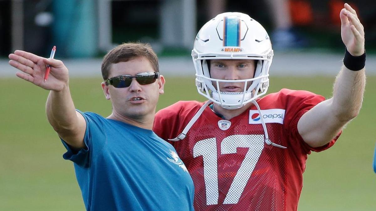 
Miami Dolphins quarterback Ryan Tannehill (17) talks with offensive coordinator Bill Lazor during training camp Tuesday, Aug. 11, 2015 in Davie, Fla.

