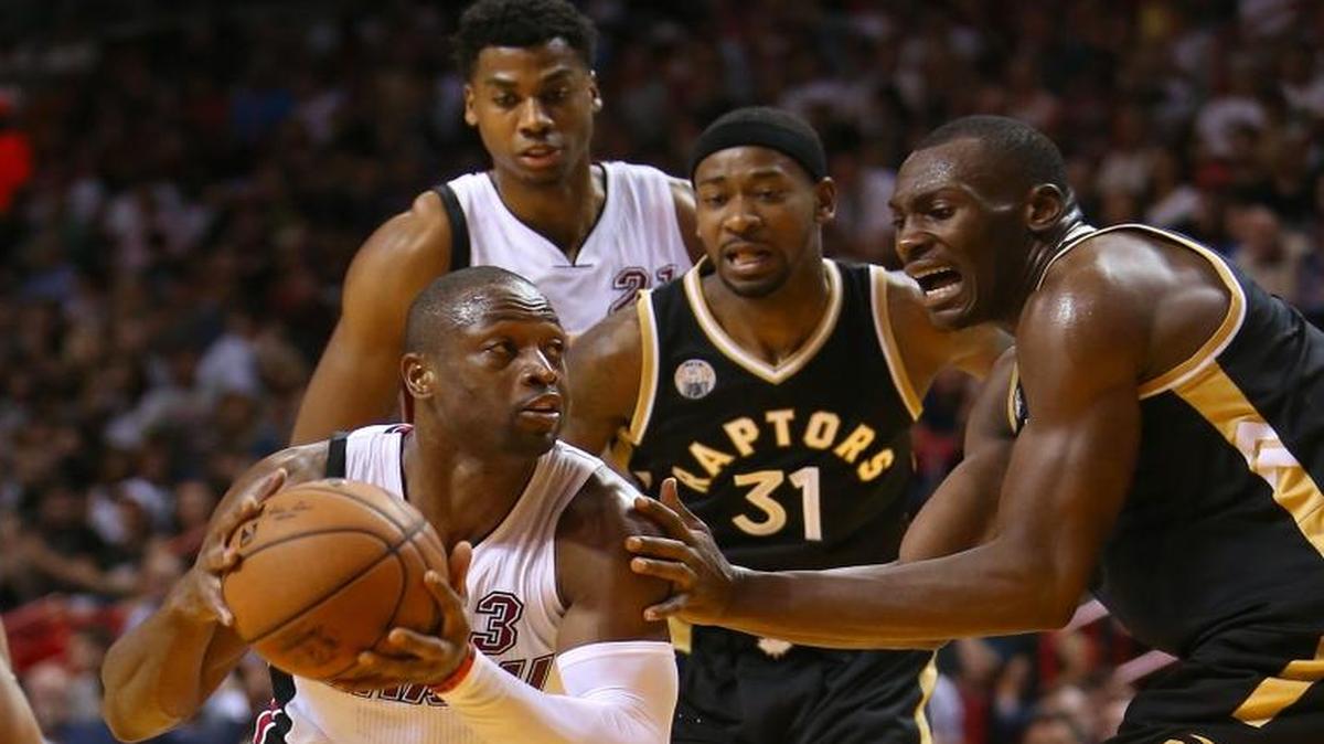 Heat guard Dwyane Wade drives to the basket against DeMar DeRozan, of the Toronto Raptors,(10), Terrence Ross,(31) and Bismack Biyombo,(8) during the second quarter of an NBA basketball game at the AmericanAirlines Arena in Miami on Fri., Dec. 18, 2015.