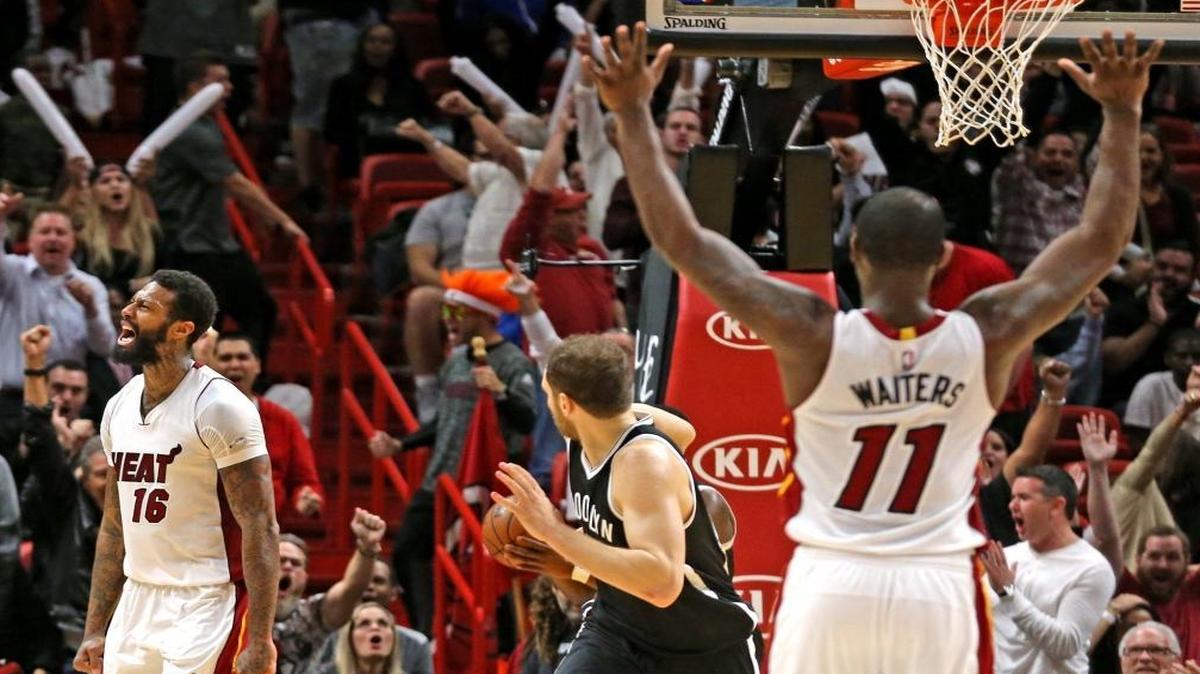 Miami Heat Dion Waiters raises his hands after James Johnson screams after a major dunk in the final seconds of the fourth quarter as they defeat the Brooklyn Nets at the AmericanAirlines Arena in Miami, Florida, Jan. 30, 2017.