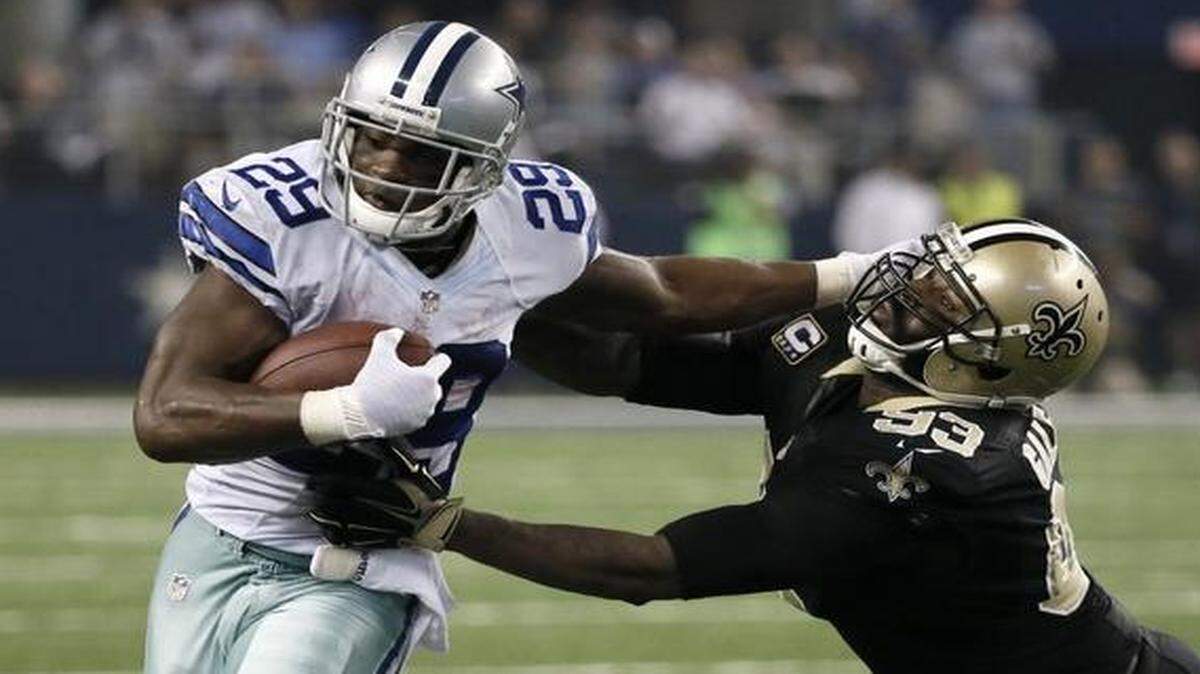 
In this Sept. 28, 2014 file photo, Dallas Cowboys running back DeMarco Murray (29) fights off a tackle attempt by New Orleans Saints’ Junior Galette during a game in Arlington, Texas. 
