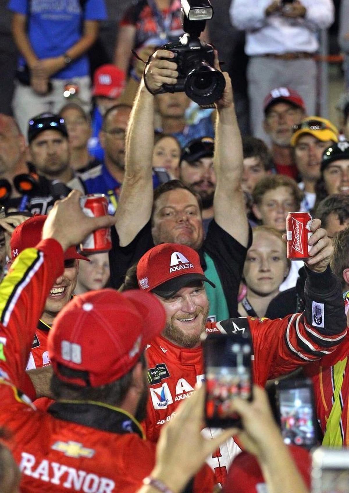 Dale Earnhardt Jr. toasts with beers with his pit crew as he ended his NASCAR career on Sun., Nov. 19, 2017. NASCAR drivers competed in the Ford EcoBoost 400 in the final race of the Ford Championship Weekend.