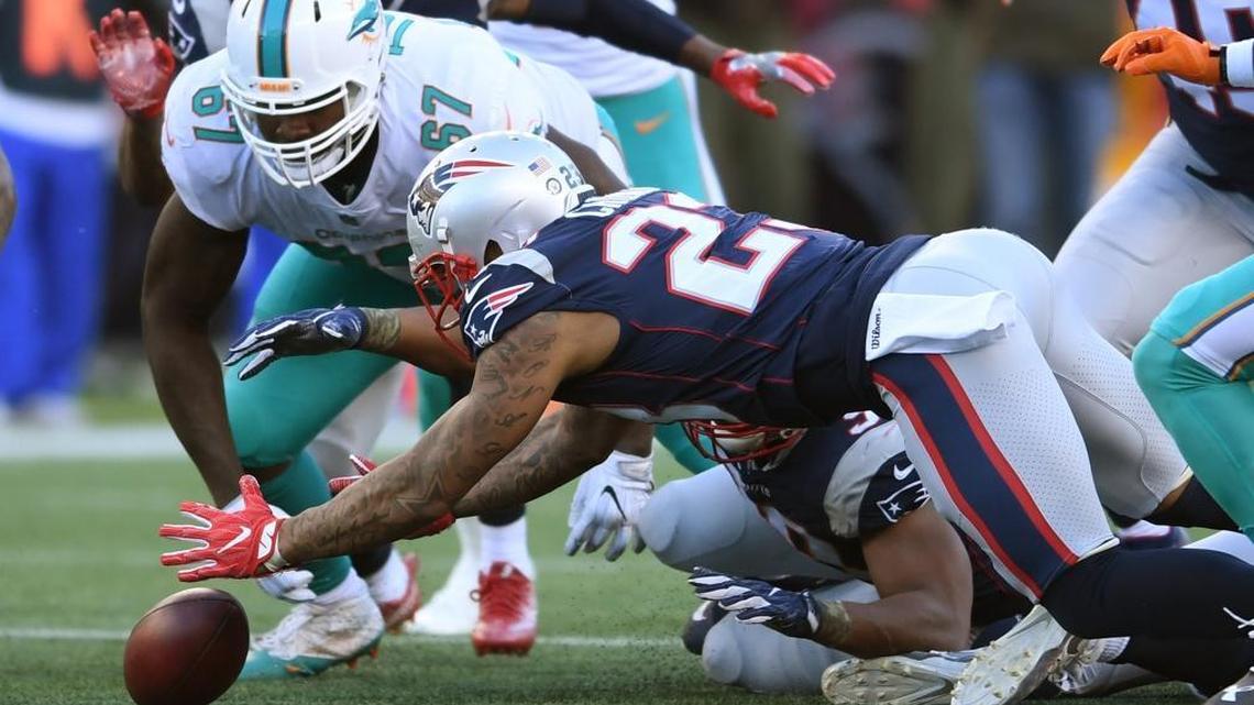 New England Patriots strong safety Patrick Chung (23) recovers a fumble by the Dolphins as Miami Dolphins defensive tackle Jordan Phillips (97) tries to recover the ball on Sun., Nov. 26, 2017 at Gillette Stadium in Foxboro, Mass.
