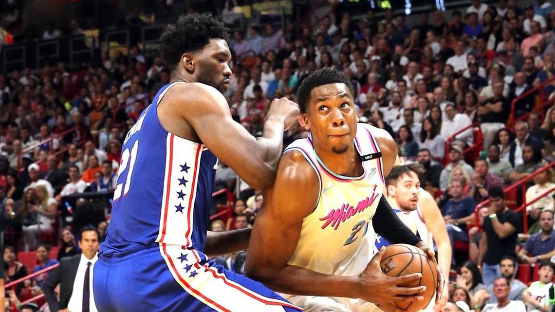 Miami Heat center Hassan Whiteside looks to the basket as Philadelphia 76ers center Joel Embiid defends him in a Feb. 27 game. The 76ers say Embiid is out for Game 1 because of a facial injury. Whiteside is looking to rebound from an inconsistent season in which he missed 28 games due to injury.