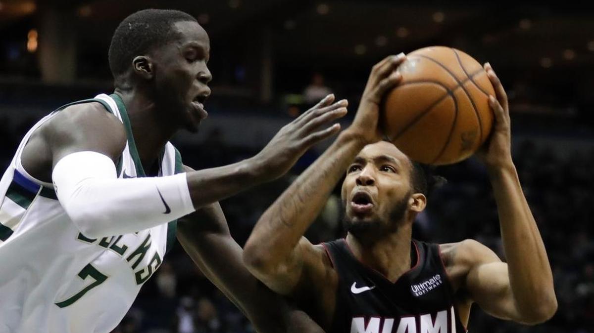 Miami Heat’s Derrick Jones Jr. tries to drive past Milwaukee Bucks center Thon Maker in a January game. Jones was very impressive in NBA summer league before sustaining an ankle injury.