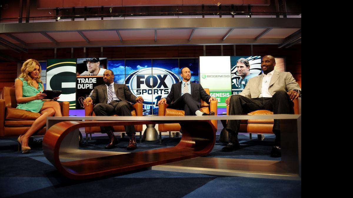 
From left, ‘Fox Sports Live’ host Charissa Thompson, NFL player Donovan McNabb, MLB player Gabe Kapler and NFL player Ephraim Salaam converse on set during rehearsals for Fox Sports 1 at Fox Studios in Los Angeles. 
