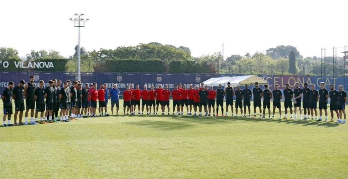 FC Barcelona players observe a moment of silence before their training session Friday morning.