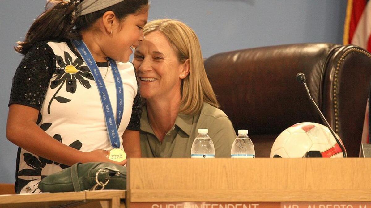 U.S. World Cup coach Jill Ellis and her daughter, Lily, at a Miami-Dade Schools ceremony celebrating the U.S. victory at the 2015 World Cup.