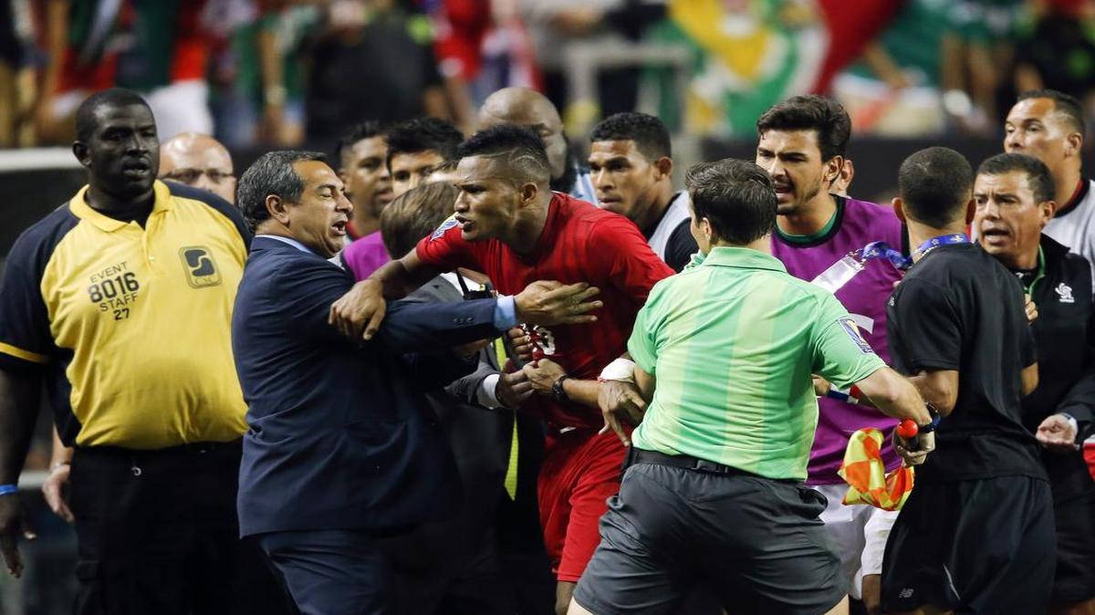 
Panama's Erick Davis (15) is restrained as tempers flare during the second half of a CONCACAF Gold Cup soccer semifinal between Panama and Mexico on Wednesday, July 22, 2015, in Atlanta. Mexico won 2-1 in extra time.
