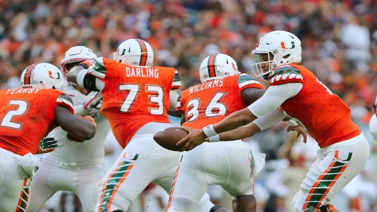 UM quarterback Brad Kaaya gives a handoff to running back Joseph Yearby in the second quarter against FAU.