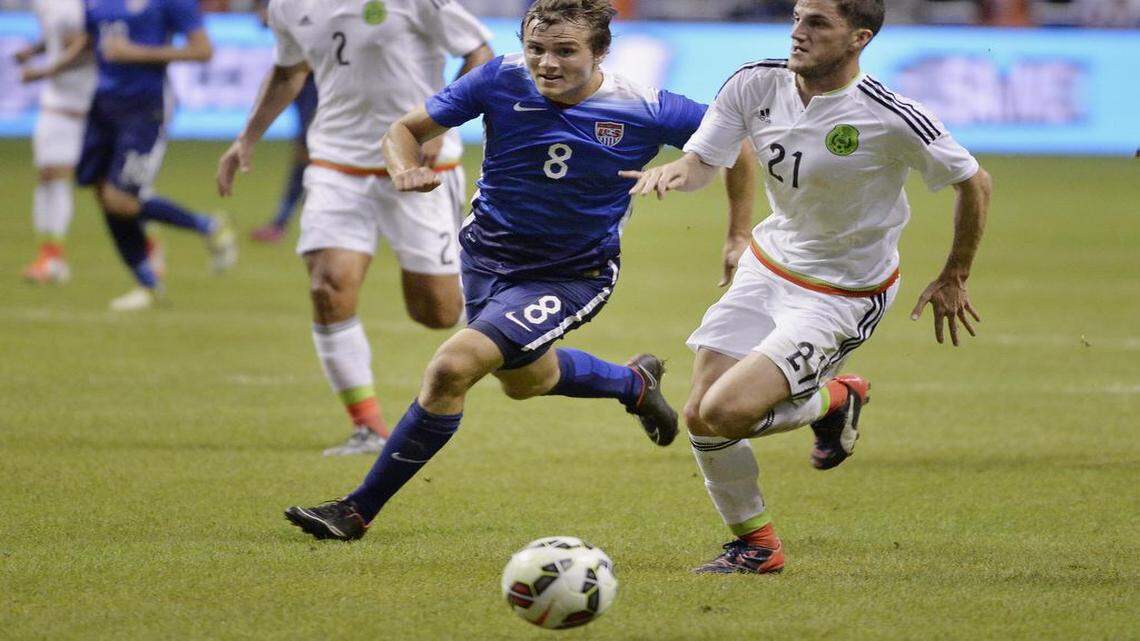 
USA defender Jordan Morris (8) chases the ball against Mexico defender Hiram Mier during the first half of an international friendly soccer match, Wednesday, April 15, 2015, in San Antonio.
