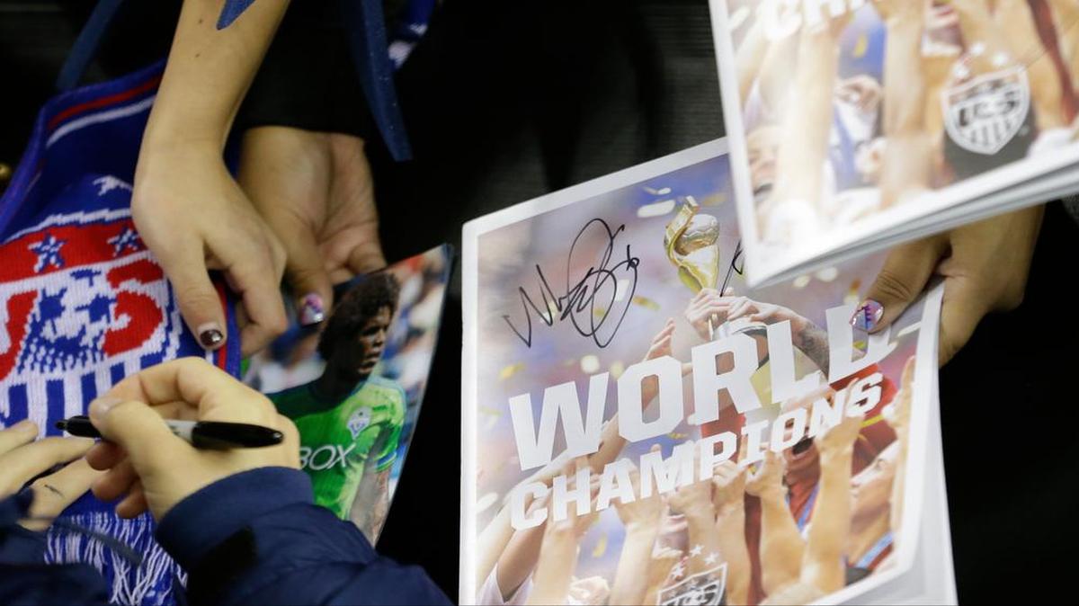 A U.S. player signs autographs after a friendly against Brazil last Wednesday, when the teams tied 1-1. They face off again Sunday in Orlando before the U.S. team goes to the White House on Tuesday to be honored by Barack Obama.