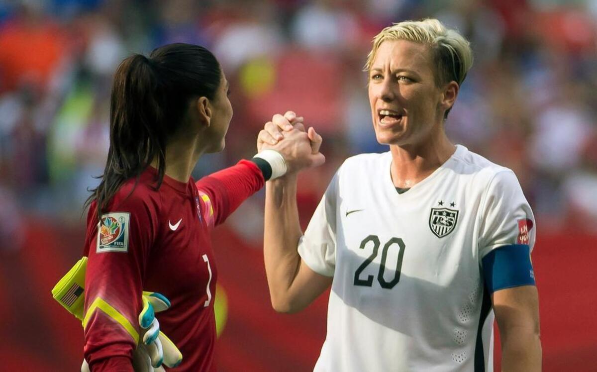 
United States' Abby Wambach (20) celebrates her team's win with goal keeper Hope Solo following the second half of a FIFA Women's World Cup soccer match, Tuesday, June 16, 2015 in Vancouver, New Brunswick, Canada 
