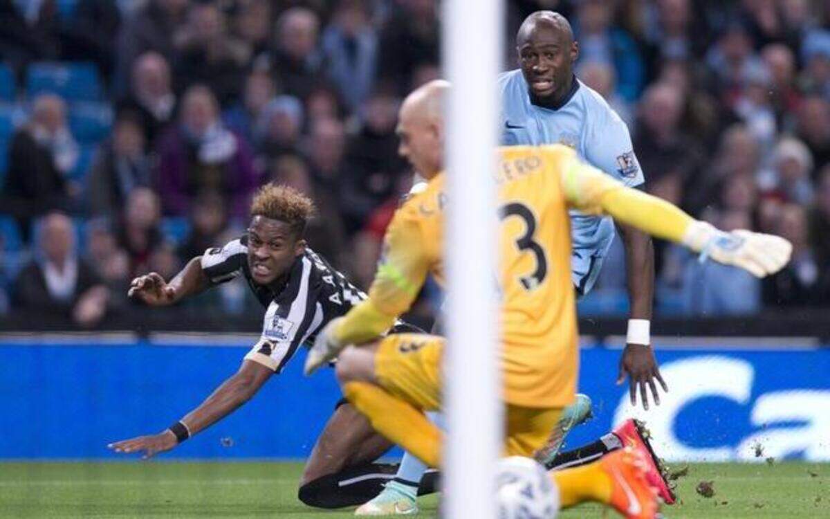 <cutline_leadin>Man City in a funk:</cutline_leadin> Newcastle United midfielder Rolando Aarons, left, scores against Manchester City’s goalkeeper Willy Caballero during Newcastle’s 2-0 win Wednesday.