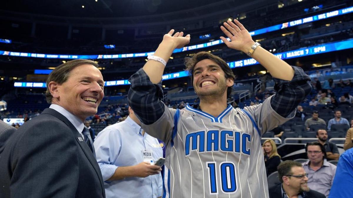 Brazilian professional soccer player Kaka, right, shows his shooting form while talking with Orlando Magic Chairman Dan DeVos before an NBA basketball game against the New York Knicks in Orlando, Fla., Wednesday, Feb. 11, 2015
