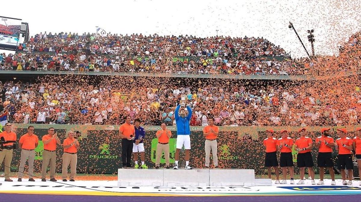 Novak Djokovic holds up his trophy as confetti rains down after beating Kei Nishikori 6-3, 6-3, to win the the Miami Open for sixth time on Sun., April 3, 2016 at Cradon Park Tennis Center in Key Biscayne, Florida.