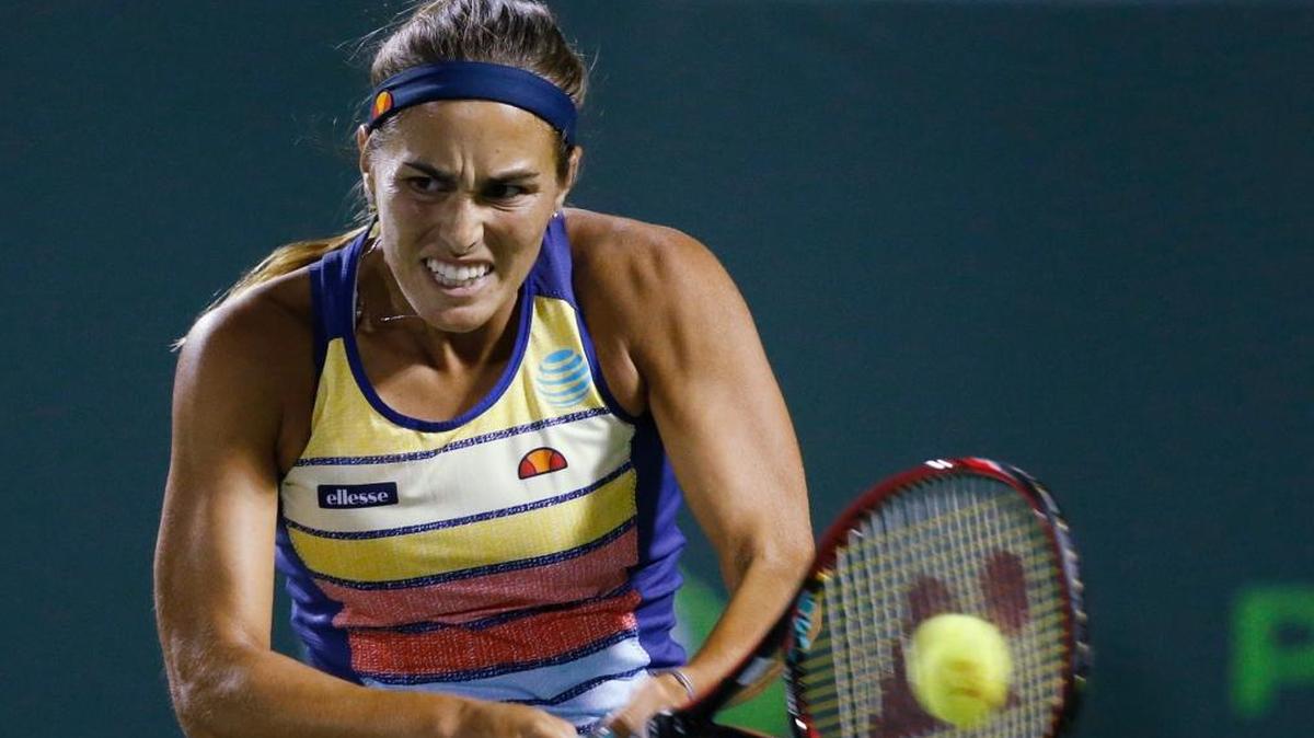 Monica Puig, of Puerto Rico, returns a shot from Caroline Wozniacki, of Denmark, at the Miami Open tennis tournament Fri., March 23, 2018, in Key Biscayne, Fla.