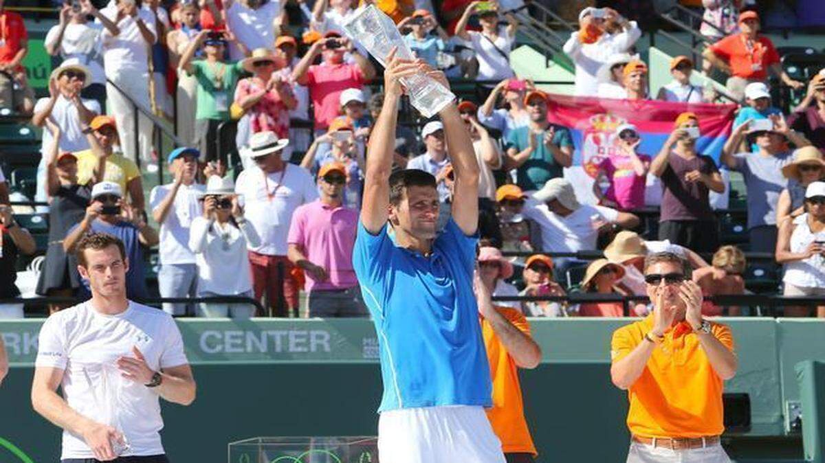 
Novak Djokovic of Serbia, holds his trophy after he defeated Andy Murray, of Great Britain,leftf in the men's final at the Miami Open tennis tournament in Key Biscayne on Sunday, April 5, 2015. Djokovic won 7 (7)-6(3), 4-6, 6-0.
