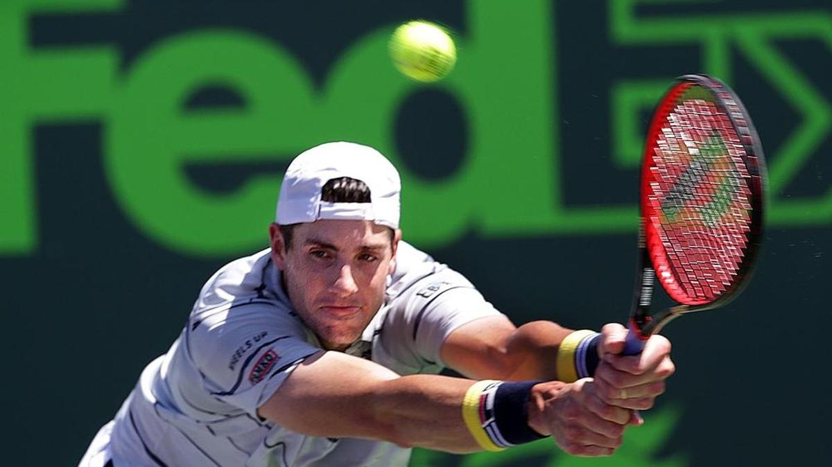 John Isner returns serve against Juan Martin Del Potro of Argentine during the men's single semifinal at the Miami Open tennis tournament at Crandon Park Tennis Center in Key Biscayne on March 30, 2018.