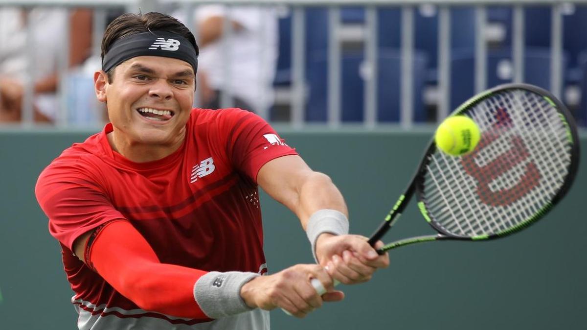 Milos Raonic, of Canada, returns the ball to Damir Dzumhur, of Bosnia, during the Miami Open tennis tournament, Tuesday, March 29, 2016, in Key Biscayne, Fla.