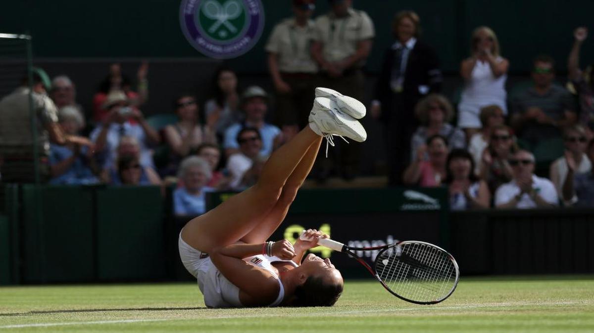
Jelena Jankovic of Serbia celebrates defeating Petra Kvitova of the Czech Republic during their singles match against at the All England Lawn Tennis Championships in Wimbledon, London, Saturday July 4, 2015. Jankovic won the match 3-6, 7-5, 6-4.

