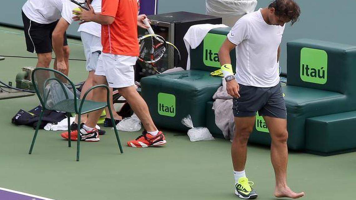 
Rafael Nadal leaves the court with his left shoe off after tripping during practice Monday, March 23, 2015 at the Miami Open.
