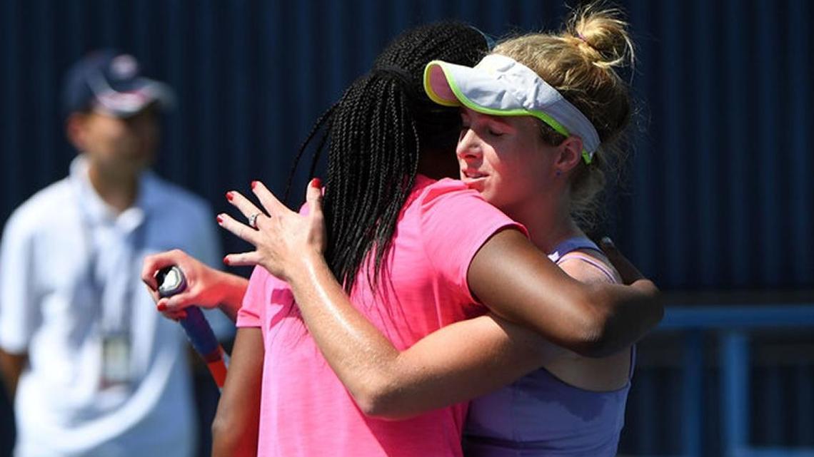 Allie Kiick (in visor), daughter of ailing Miami Dolphins legend Jim Kiick, hugs Victoria Duval after their match at the 2017 US Open.