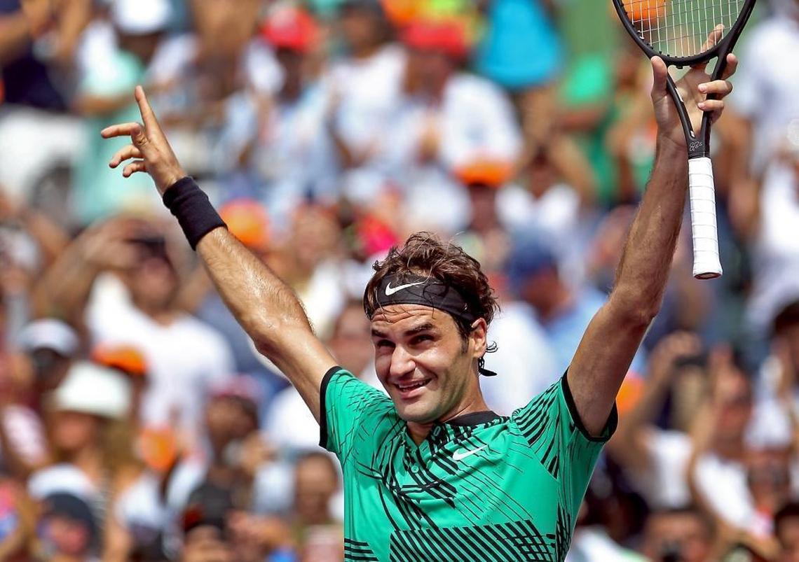 Roger Federer holds his hands up in celebration after winning the men's final at the Miami Open between Roger Federer and Rafael Nadal at the Crandon Park Tennis Center on April 2, 2017.