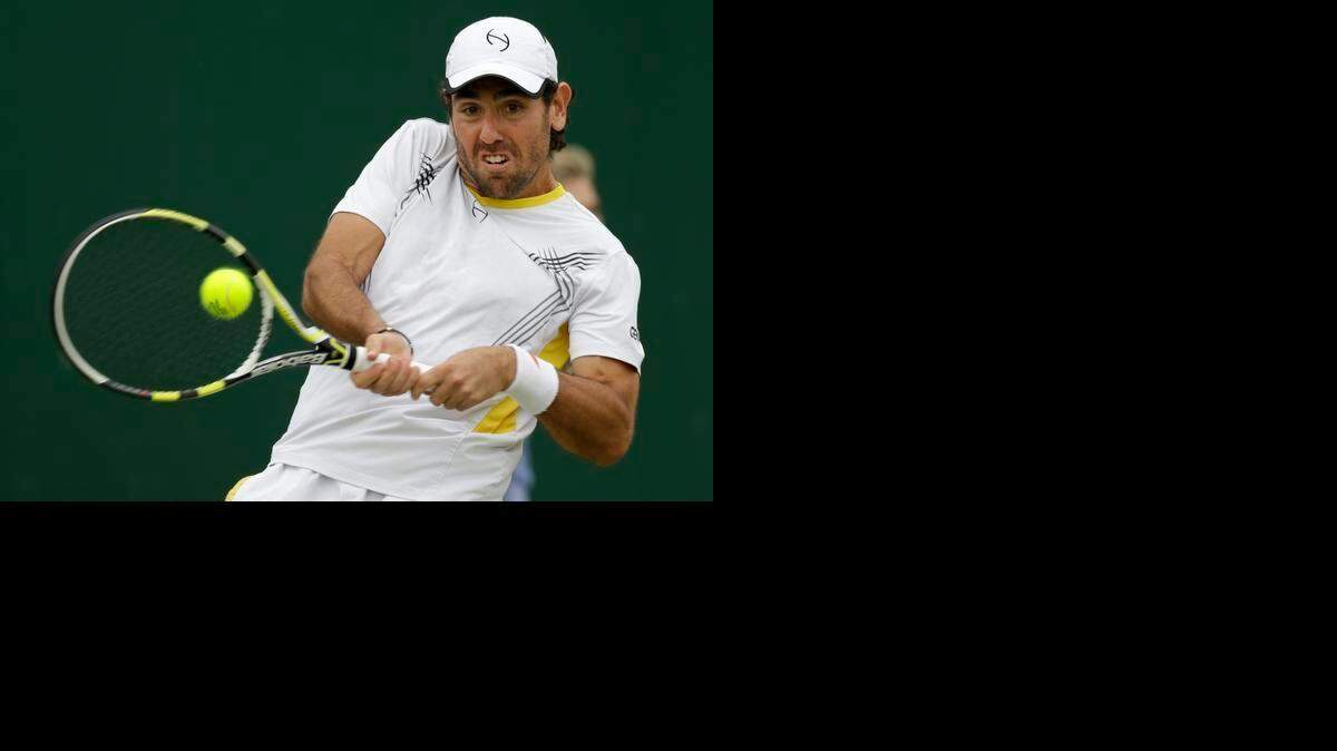 
Wayne Odesnik returns a shot during a first-round match against Bjorn Phau of Germany at Wimbledon on Wednesday, June 27, 2012. 
