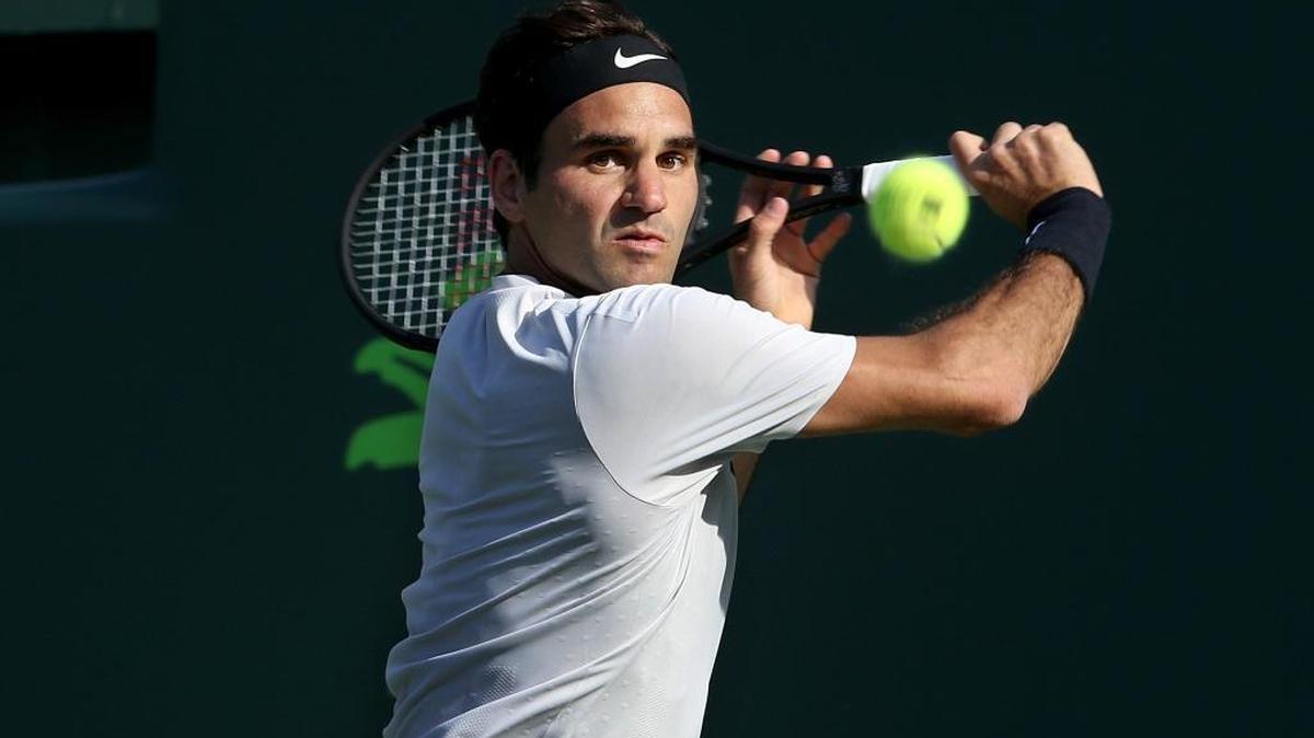 Roger Federer ,of Switzerland, currently ranked world No.1 in men's singles tennis by the ATP, returns against Thanasi Kokkinakis, of Australia, during the men's single second round at the Miami Open Saturday, March 24, 2018, at Crandon Park Tennis Center on Key Biscayne.