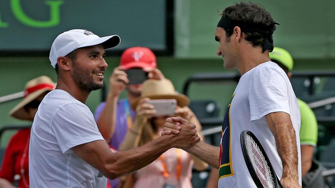 Roger Federer shakes hands with his hitting partner Adrian Escarate prior to the men's final at the Miami Open between Roger Federer and Rafael Nadal at the Crandon Park Tennis Center on Sunday, April 2, 2017.