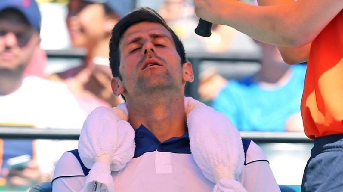 Novak Djokovic rests with his eyes closed in a two-set loss to Benoit Paire at the 2018 Miami Open on Friday.