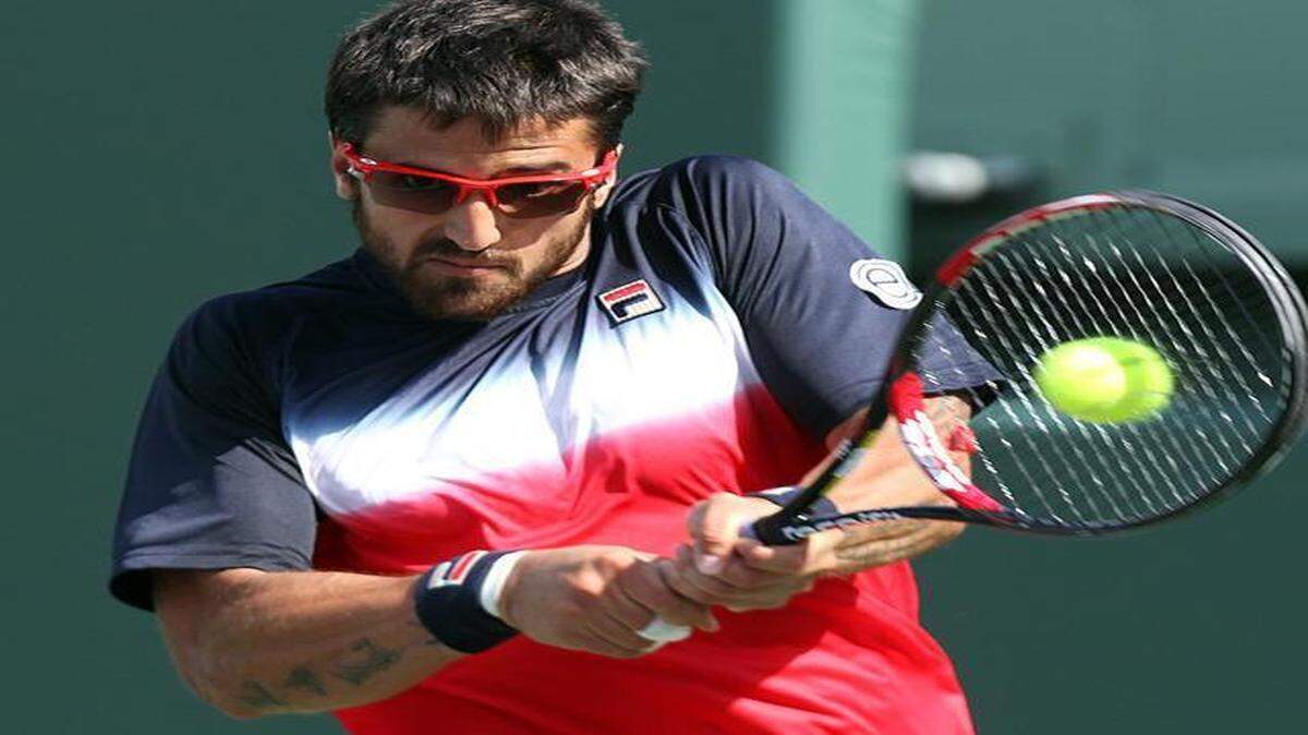 
Janko Tipsarevic returns a shot at the Miami Open against Andy Murray on March 28, 2012. In 2013, Tipsarevic underwent two surgeries to remove benign tumors from his left heel.
