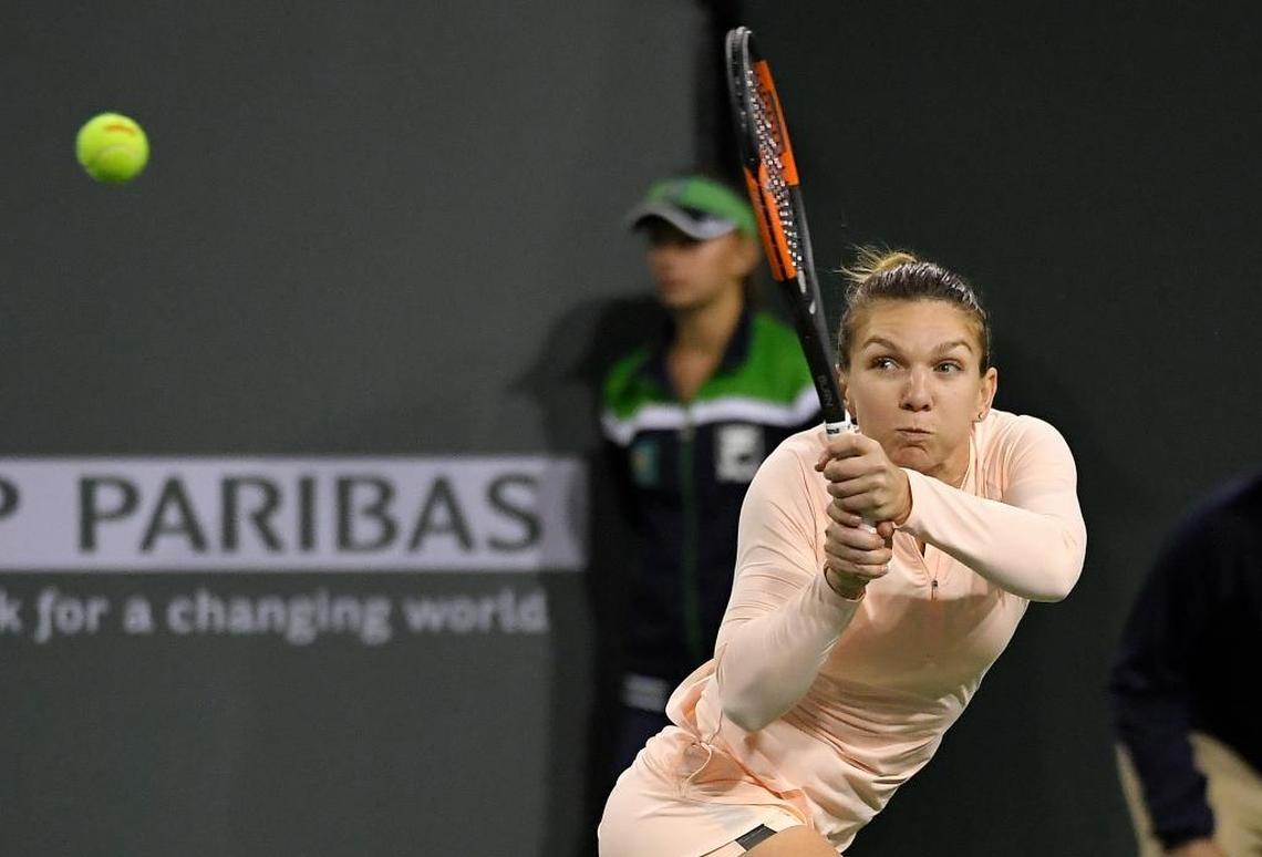 Simona Halep, of Romania, returns a shot against Naomi Osaka, of Japan, during the semifinals at the BNP Paribas Open tennis tournament on March 16, 2018, in Indian Wells, Calif.