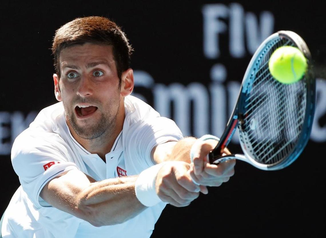 Serbia's Novak Djokovic makes a backhand return to Uzbekistan's Denis Istomin during their second round match at the Australian Open tennis championships in Melbourne, Australia.