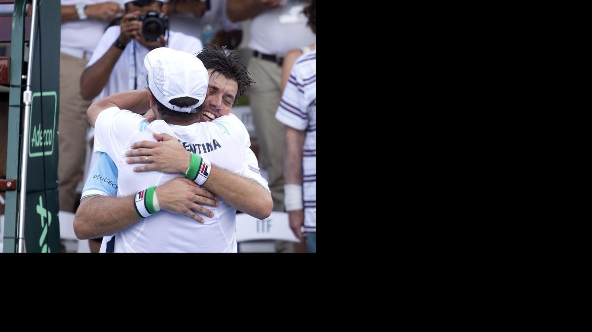 
Carlos Berlocq, of Argentina, hugs a teammate after defeating Bar Tzuf Botzer, of Irsael during Davis Cup tennis play in Sunrise, Fla., Sunday, Sept. 14, 2014. Berlocq won 2-6, 3-6, 0-6. 

