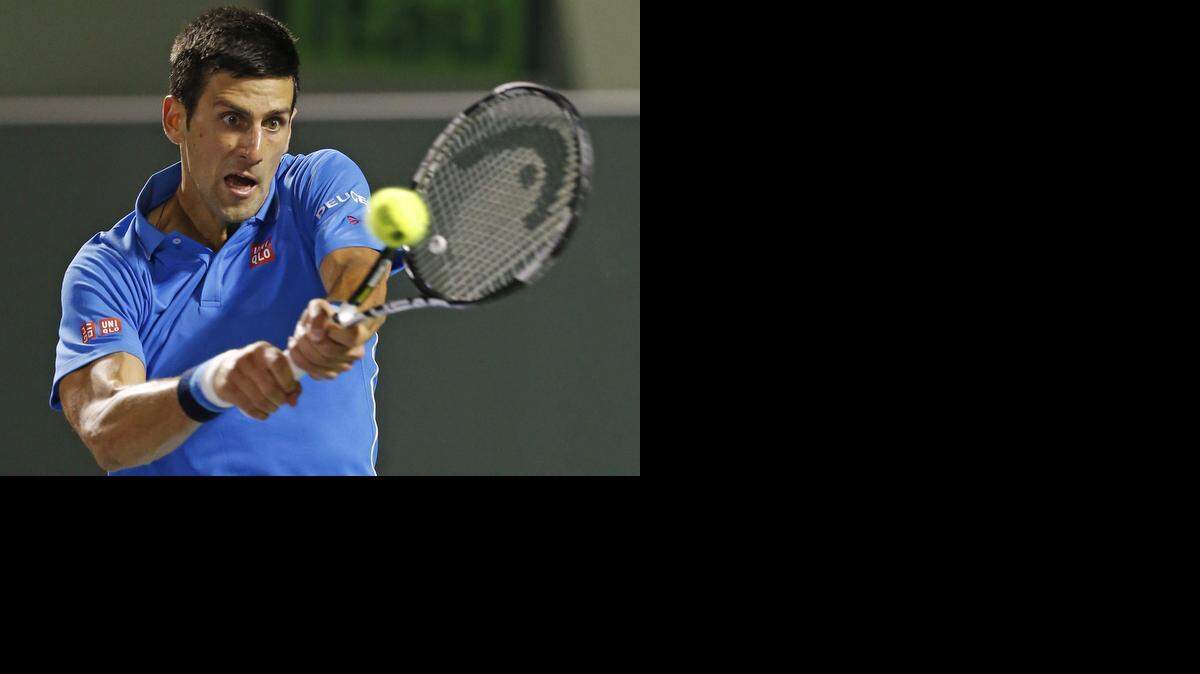 
Novak Djokovic returns a serve by Martin Klizan during the Miami Open tennis tournament at Crandon Park Tennis Center in Key Biscayne on March 28, 2015.
