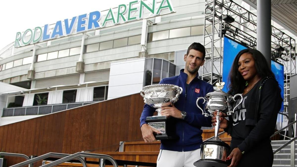 Defending champions Serena Williams of the US and Serbia's Novak Djokovic pose for a photo with their trophies as they arrive for the official draw at the Australian Open tennis championships in Melbourne, Australia, Friday, Jan. 15, 2016.