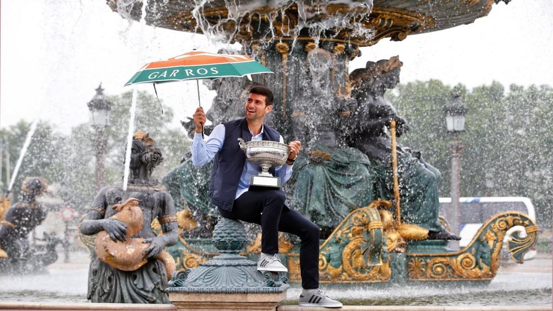 Novak Djokovic poses with the French Open tennis trophy during a photo session at the Place de la Concorde in Paris on June 6. The title completed a career Slam for him.