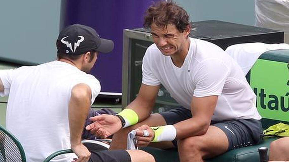 
Rafael Nadal grimaces after tripping during a practice session at the Miami Open in Key Biscayne on Monday, March 23, 2015. 
