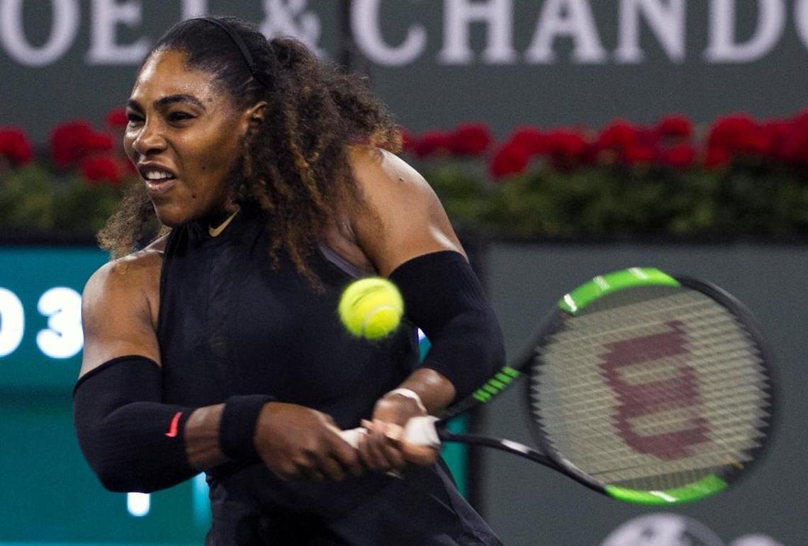 Serena Williams returns a shot to opponent and sister Venus Williams during the third round of the BNP Paribas Open tennis tournament at the Indian Wells Tennis Garden in Indian Wells, Calif., on March 12, 2018.