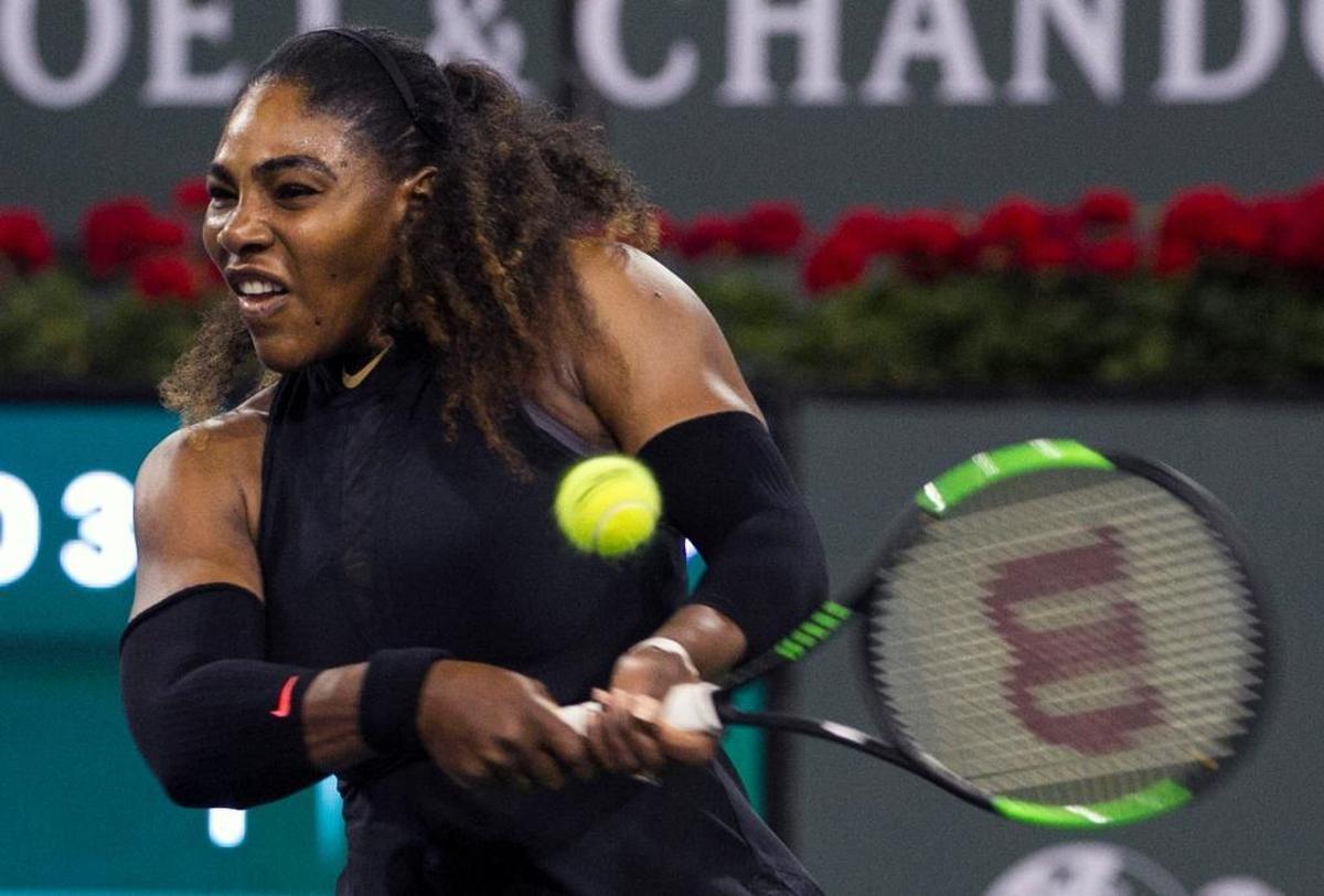 Serena Williams returns a shot to opponent and sister Venus Williams during the third round of the BNP Paribas Open tennis tournament at the Indian Wells Tennis Garden in Indian Wells, Calif., on March 12, 2018.