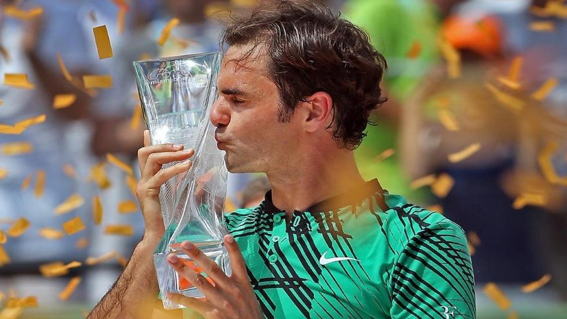 Roger Federer kisses his trophy after winning the men's final at the Miami Open between Roger Federer and Rafael Nadal at the Crandon Park Tennis Center on Sunday, April 2, 2017.