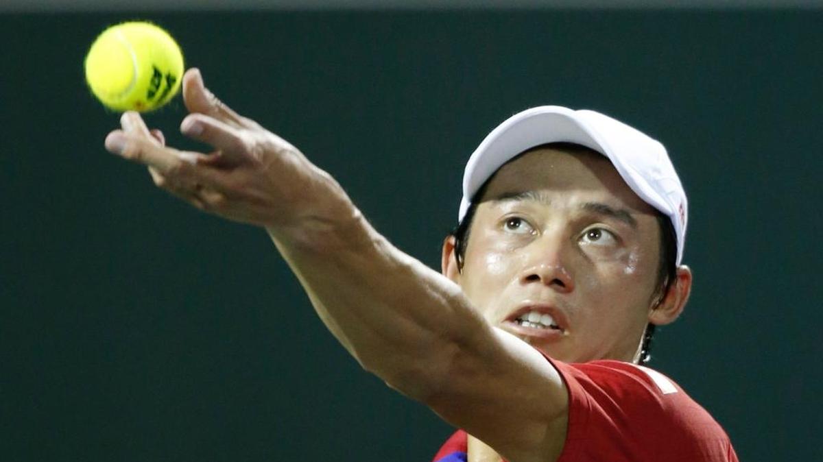 Kei Nishikori of Japan serves to Nick Kyrgios of Australia in the men's semifinals of the Miami Open on Key Biscayne on Friday, April 1, 2016.