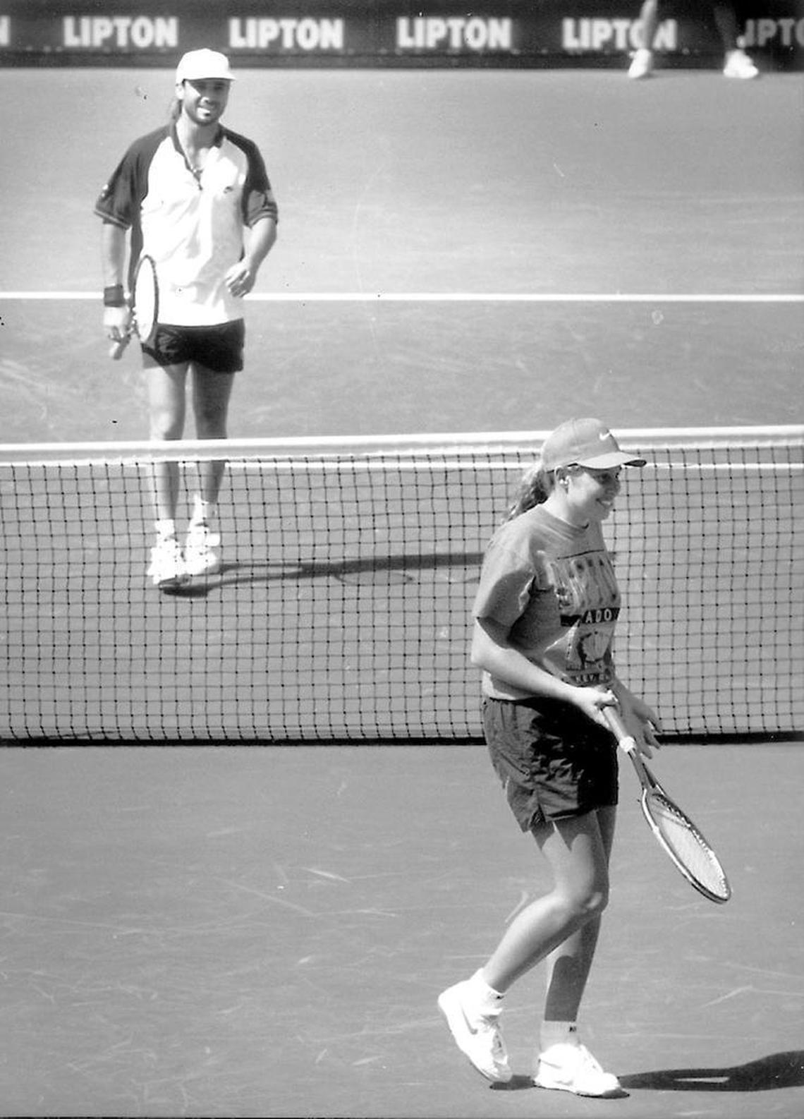 Seventeen-year-old Stephanie Flaherty uses Boris Becker's racquet to play a point against Andre Agassi after a frustrated Becker gave the ball girl his racquet on March 14, 1994.