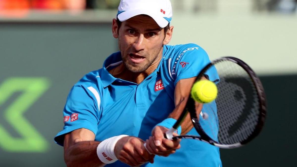 Novak Djokovic returns a shot during his match with Joao Sousa at the Miami Open at the Tennis Center at Crandon Park on Sunday, March 27, 2016.